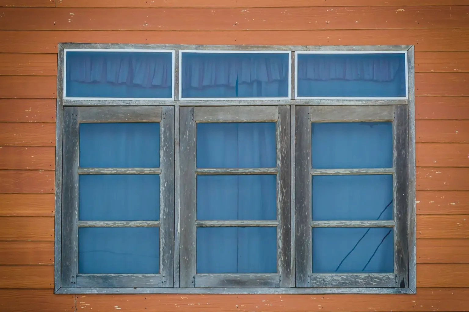 A series of wood windows in a home.